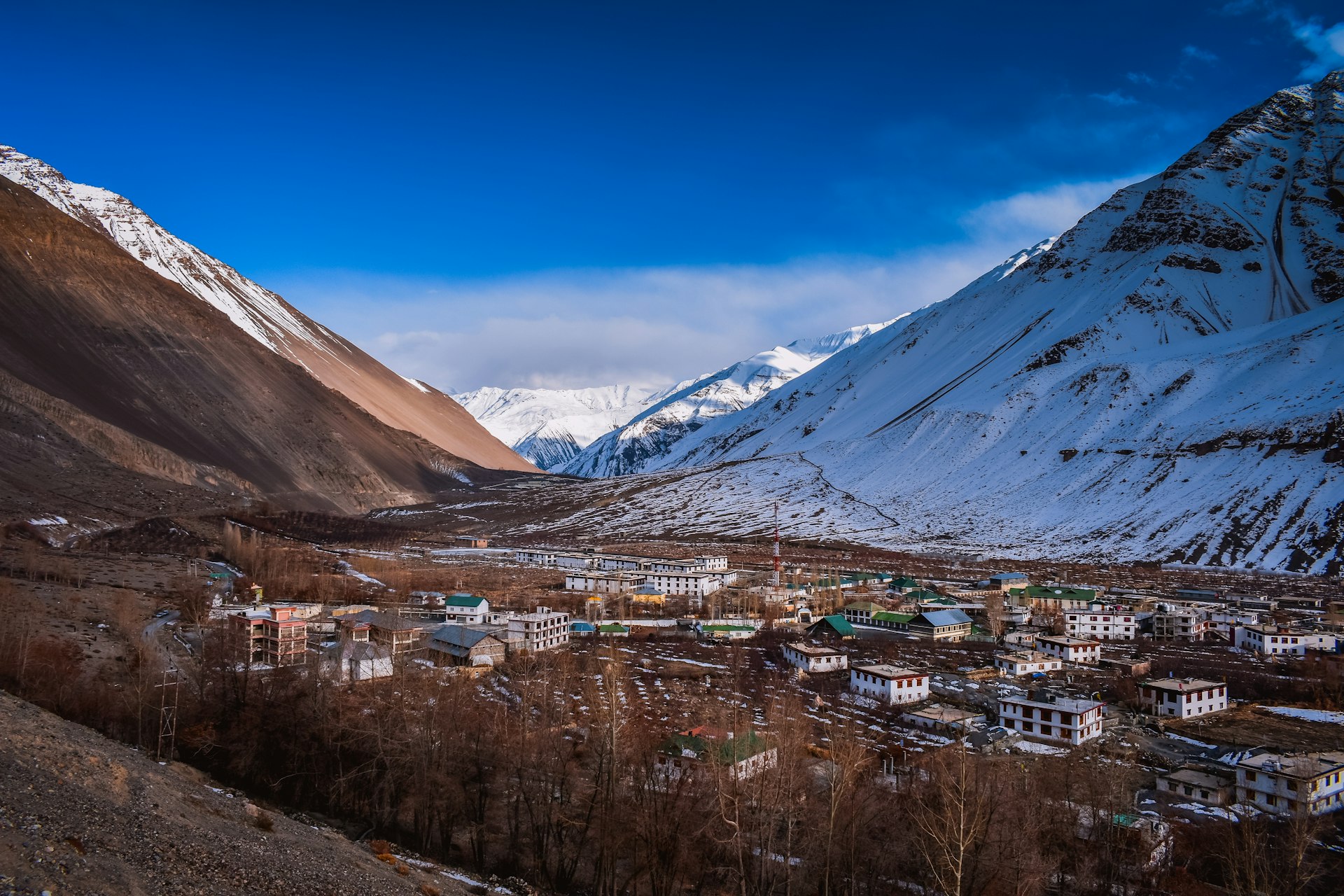 city near mountain under blue sky during daytime