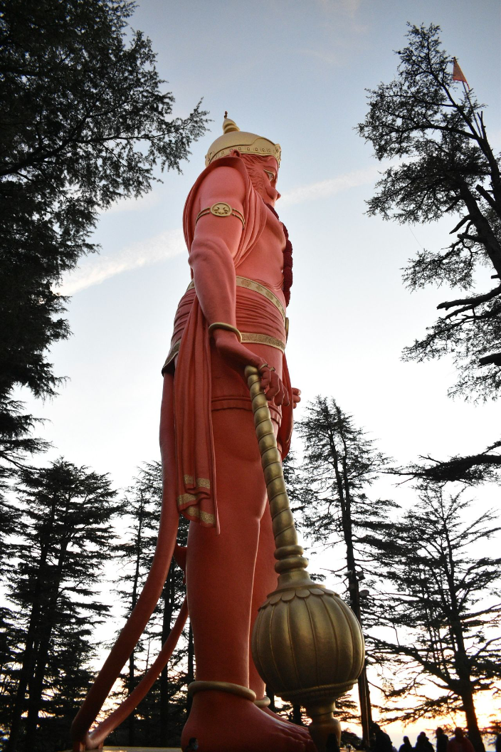 a statue of a man holding a large ball